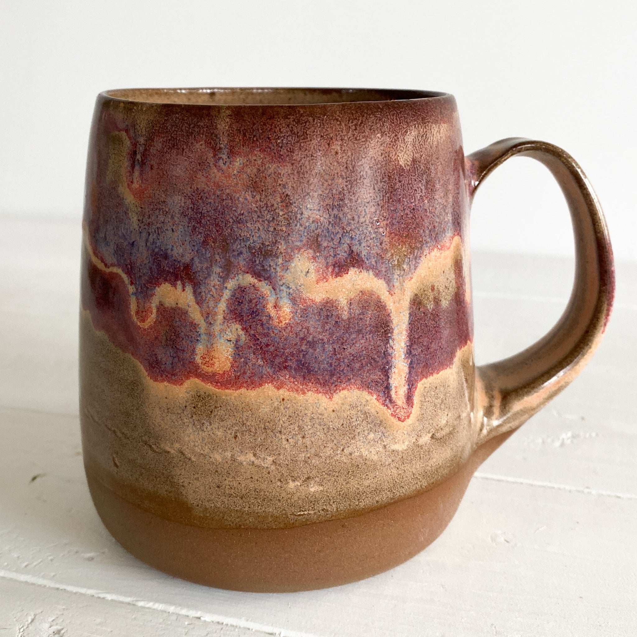 Ceramic mug with marbled design on a white surface