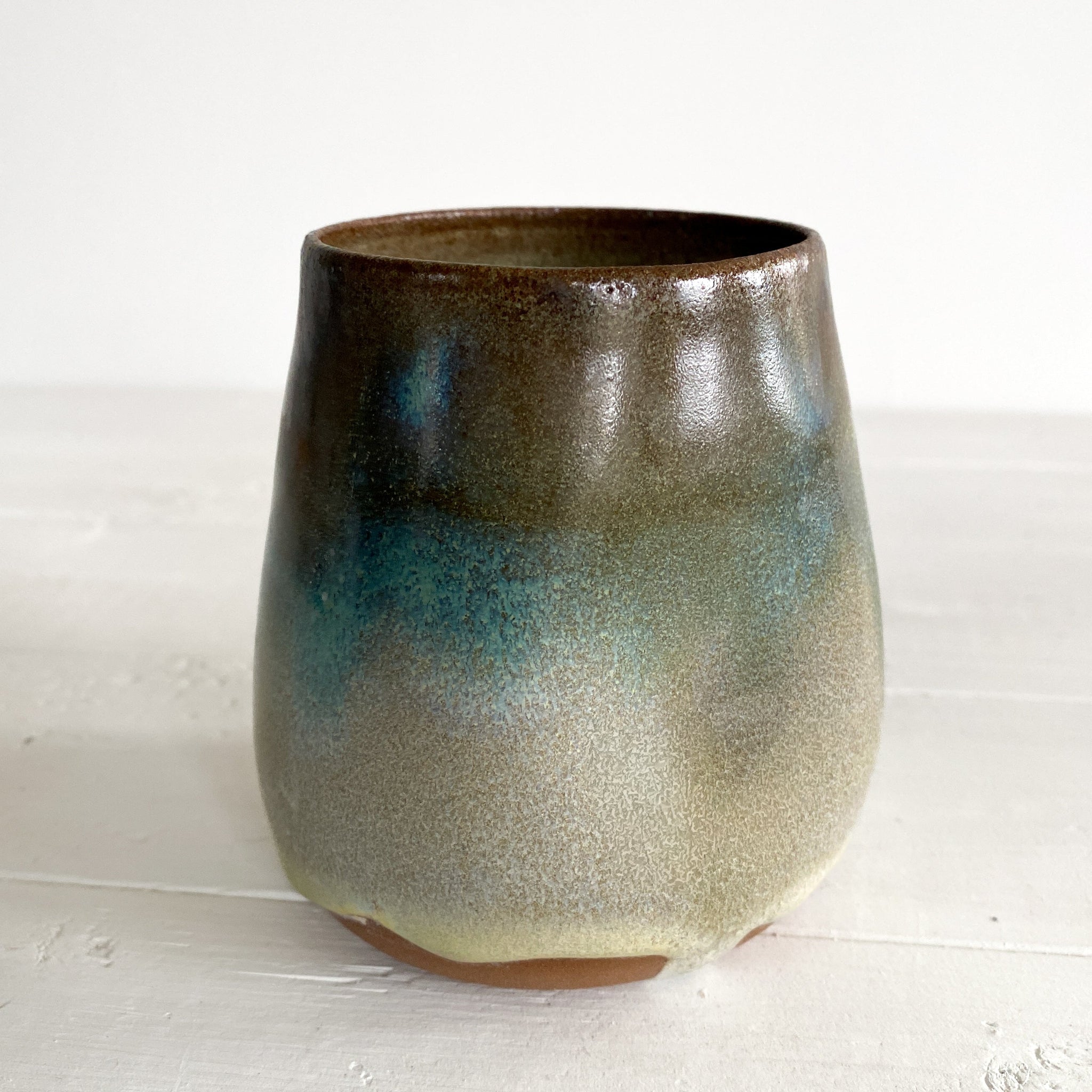 Ceramic cup with gradient finish on a white surface