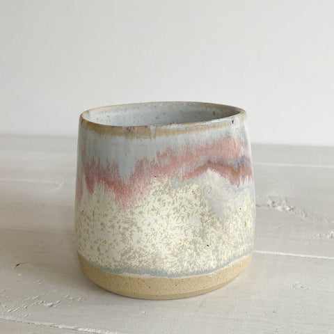 Ceramic cup with gradient color on a light surface