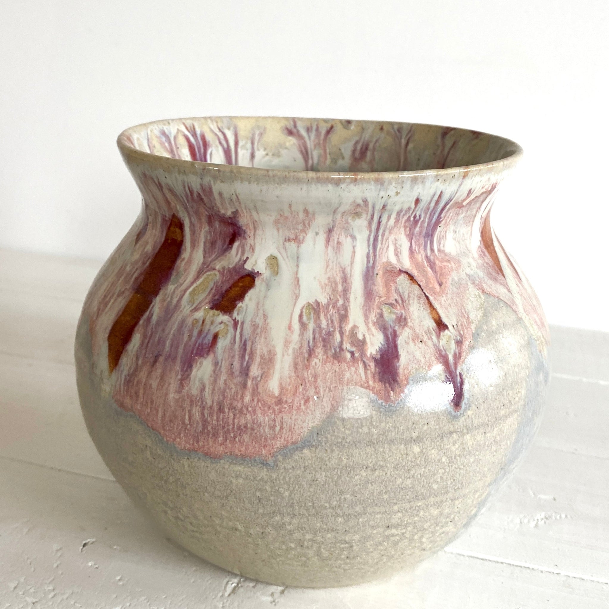 Ceramic vase with marbled design on a white surface