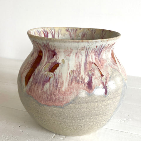 Ceramic vase with marbled design on a white surface
