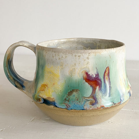 Ceramic mug with abstract design on a white surface