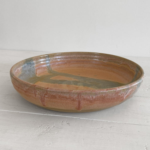 Ceramic bowl with a textured surface on a white wooden floor