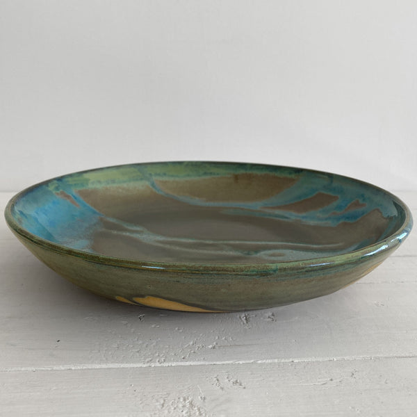 Green ceramic bowl on a white surface