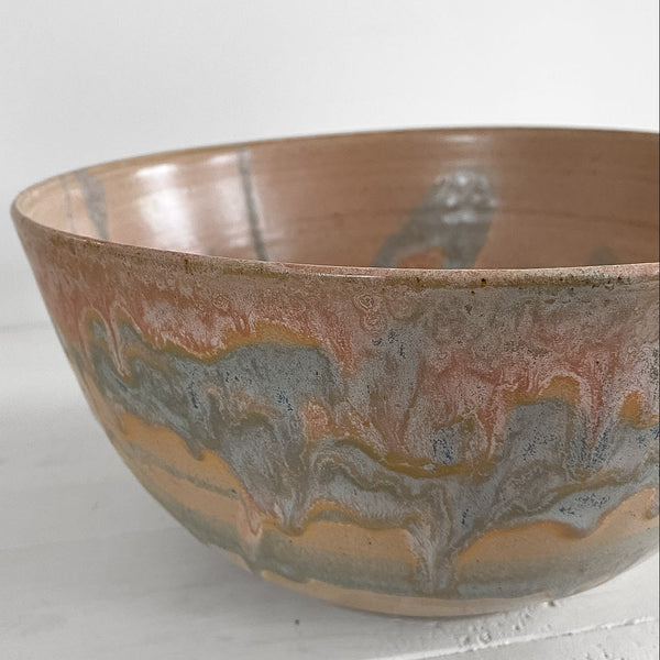 Ceramic bowl with marbled design on a light gray background